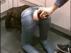 A massive bottle of champagne is squeezed through her narrow back door.